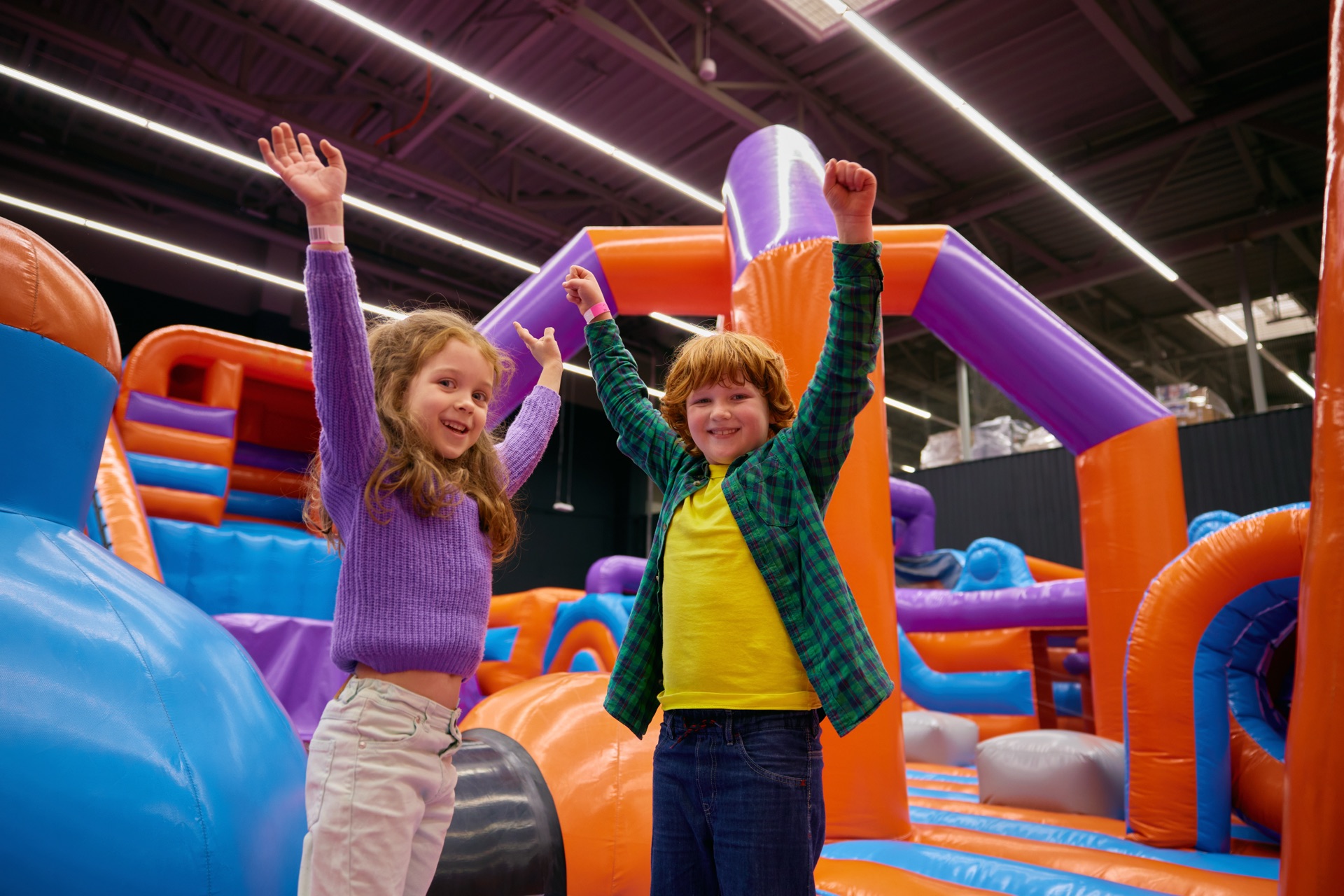 Children raising their hands together at a group activity